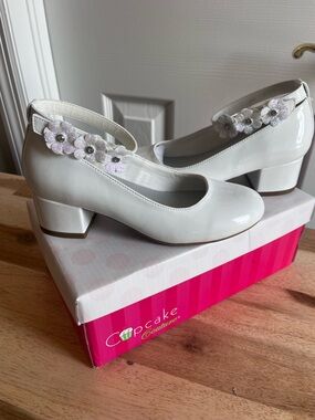 New in original box Cupcake Couture white patent leather shoes.  Kids size 1